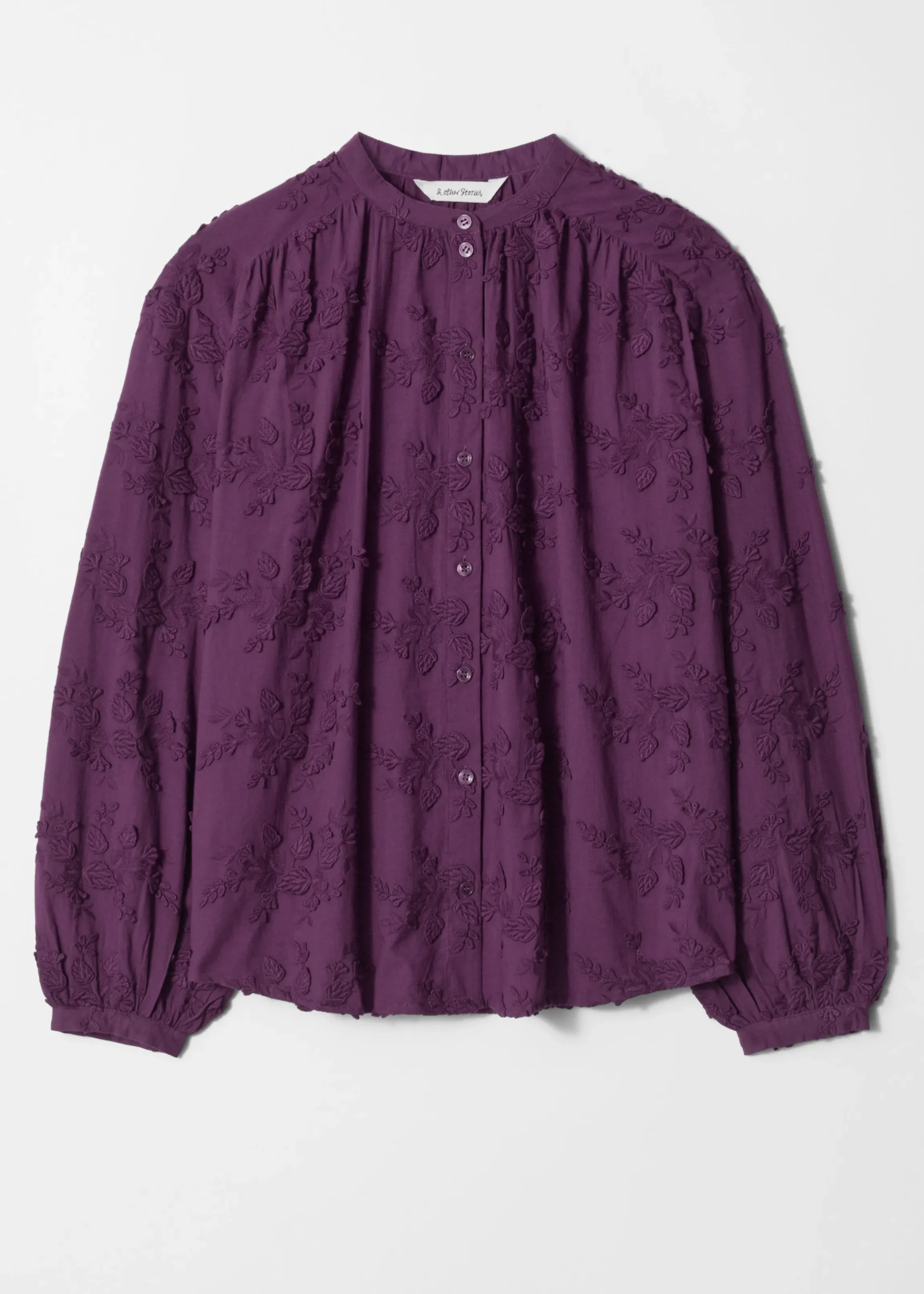 Voluminöse Bluse mit Blumenapplikation
